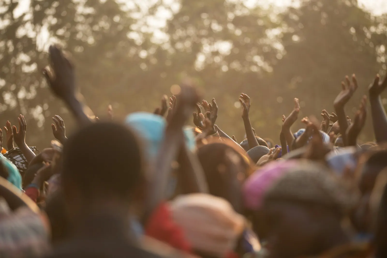 Young people with hands raised in worship